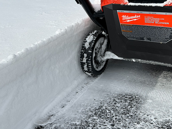 Milwaukee Cordless Snow Blower Next to Deep Snow after Working Pass